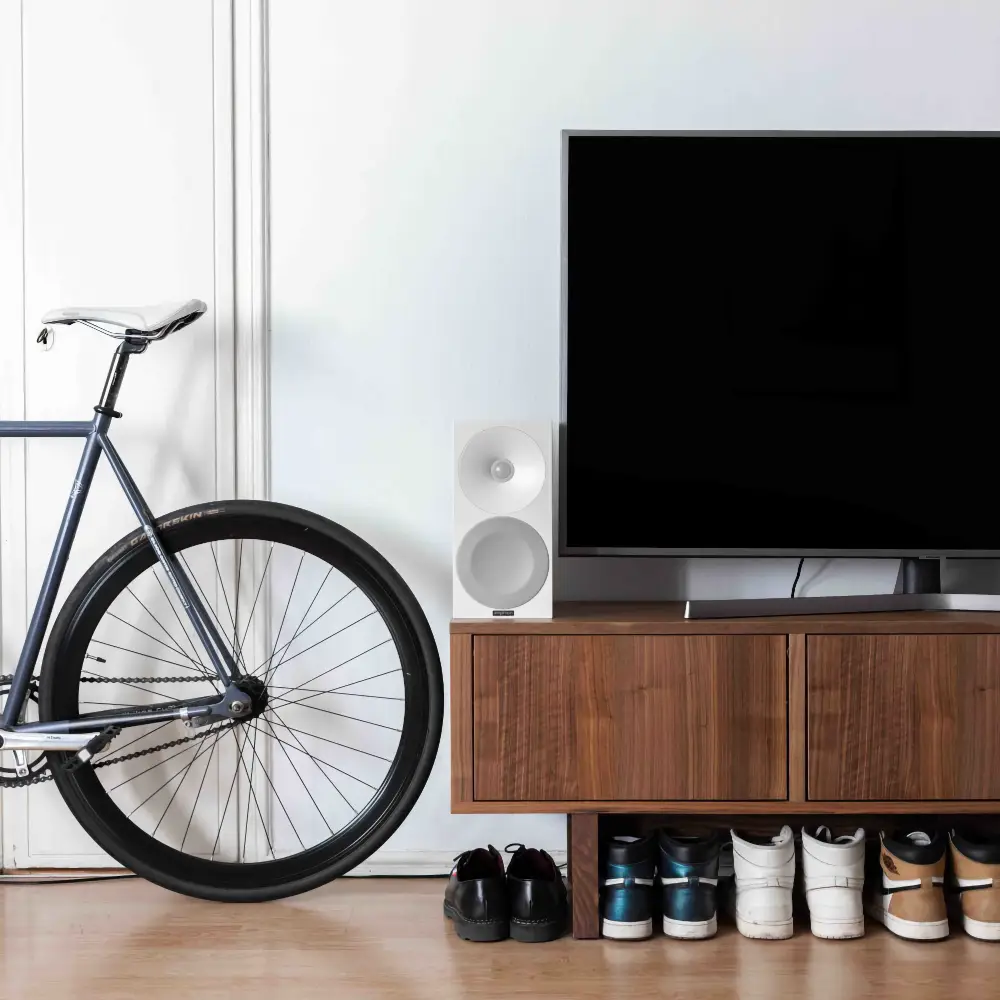 Amphion Helium 510 in full white next to a TV